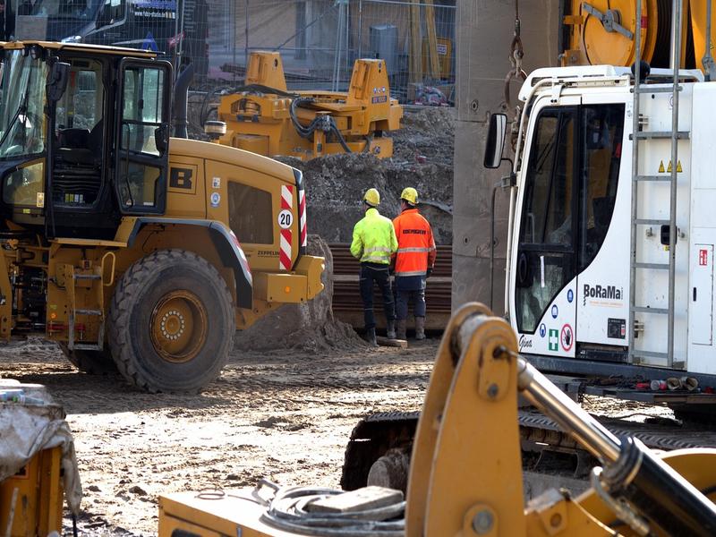 Construction site manager with team of workers